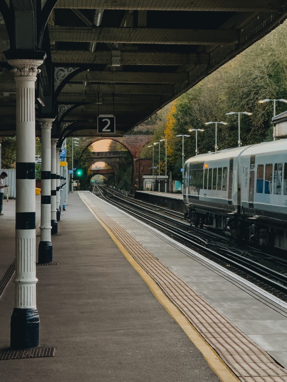 An Apple ProRAW photo of a railway station platform after a teal and orange LUT has been applied in RAWCraft